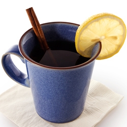 Chaos Calmer Tea in a Blue mug with a lemon slice on top.