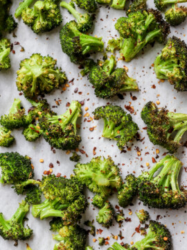 Addictive Charred Broccoli on parchment paper