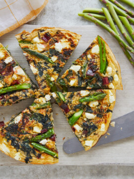 asparagus, swiss chard and feta frittata on parchment paper