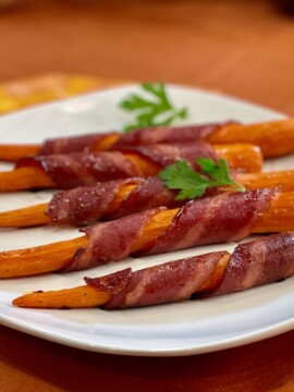Bacon-Wrapped Carrots on a white plate