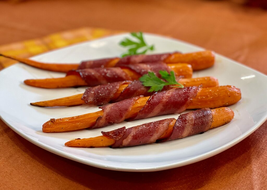 Bacon-Wrapped Carrots on a white plate