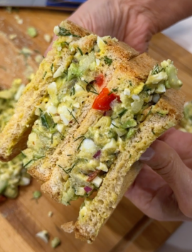 Mediterranean Chopped Salad Sandwich on a wood chopping block