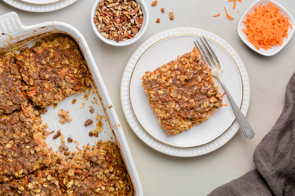 Baking dish of carrot cake baked oatmeal with one square removed.
